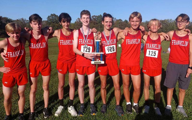 Photo courtesy of Melissa Ward - Men’s cross country team members (from left) David Olaski, Andrew Garrison, Landon Chavonic, Barrett Stork, Logan Russo, Aaron Ashe, Dominic Faetz and Cooper Tyler show off their second-place trophy from the Mountain 7 Conference Championship Oct. 19.
