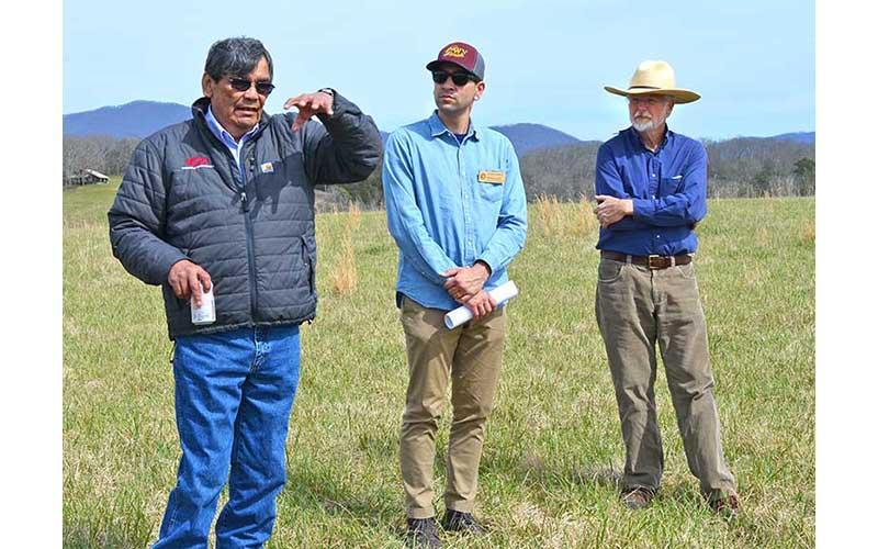 Press photo/Mia Overton - Dr. Thomas Belt talks about Cherokee history at the Watauga Mounds (pictured below) as Joseph Owle and Brett Riggs listen. Staff members from the state Department of Natural and Cultural Resources visited the Cherokee mound sites in Macon County last week.