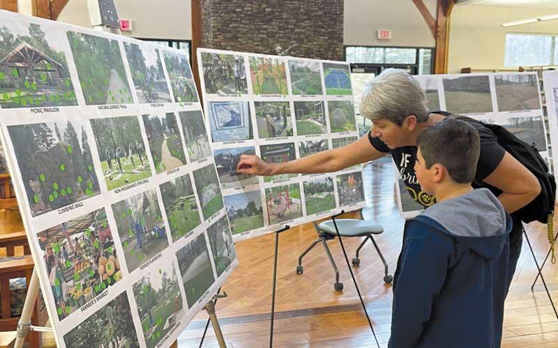 Press photo/Mia Overton - Donna Jones and eight-year-old Hunter Duncan cast their votes for what they would like to see at the Whitmire property. The town held three public drop-in meetings on Feb. 23 to gather public input on a recreation plan being developed. An online survey will be available through Friday.
