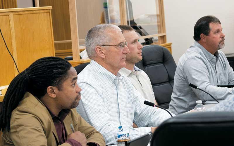 Photo/Bob Scott - Commissioners Danny Antoine, Paul Higdon, Josh Young and John Shearl listen to public comments during the March 14 Macon County Board of Commissioners meeting.