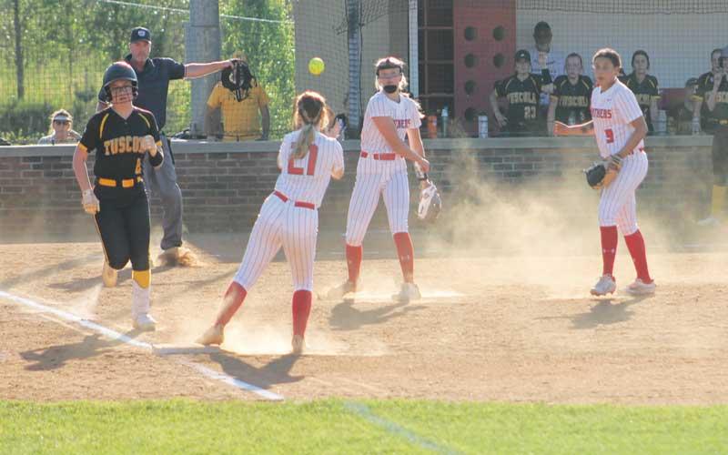 Press photo/Will Woolever - Freshman pitcher Kendall Rumans throws to senior Tessa Dehart at first in Franklin’s 12-5 victory over Tuscola April 18.