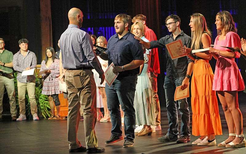 Press photo/Will Woolever - Senior Seth Brewer accepts the Male Scholar-Athlete of the Year award from assistant athletic director Ryan Haley at the FHS Athletic Awards Ceremony May 25.