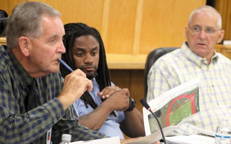 Press photo/Thomas Sherrill - Commissioner Gary Shields (left) makes a point about the Macon Middle School track during a discussion at the June 13 commissioners’ meeting. Also pictured are Commissioner Danny Antoine and Chair Paul Higdon.