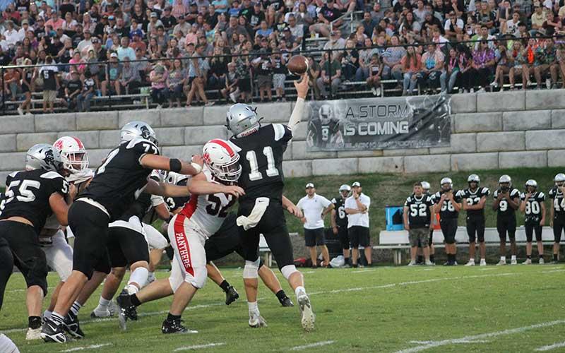 Press photo/Will Woolever - Junior Josh McGaha hits Robbinsville quarterback Donovan Carpenter as he throws.