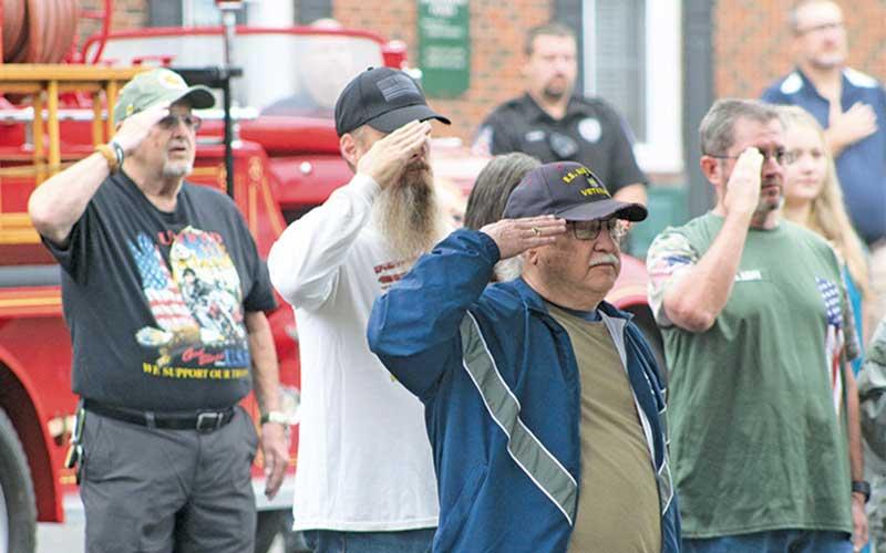Press photo/Thomas Sherrill - Veterans salute the American flag during a singing of the National Anthem at Monday morning’s 9/11 remembrance event in downtown Franklin.