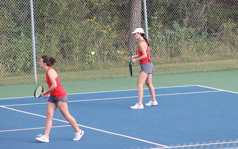Press photo/Will Woolever - Junior Maci Stork (right) forehands a ball in a doubles match with Logan Guynn versus Pisgah Sept. 25.