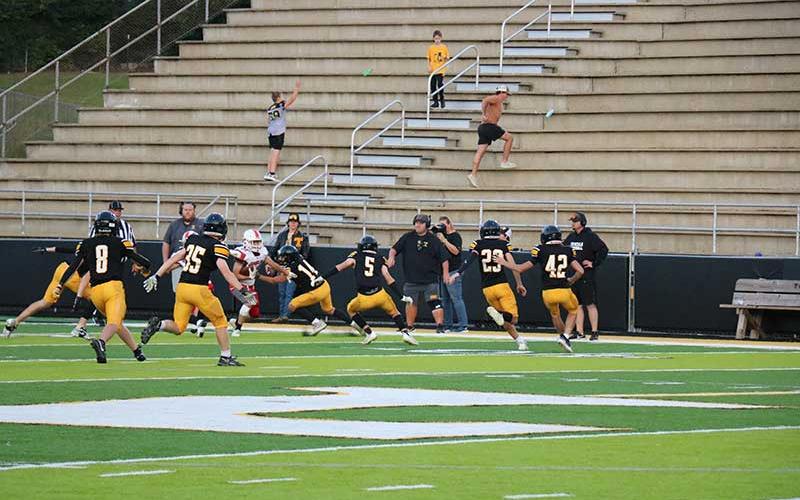 Photo courtesy of Blair King  - Sophomore wide receiver/defensive back Mark Vanhook tries to break a tackle against Tuscola Sept. 21.