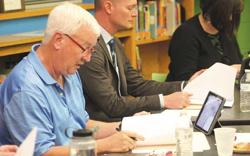 Press photo/Thomas Sherrill - School Board Chair Jim Breedlove reviews the agenda prior to the start of the Nov. 27 meeting at East Franklin Elementary School.
