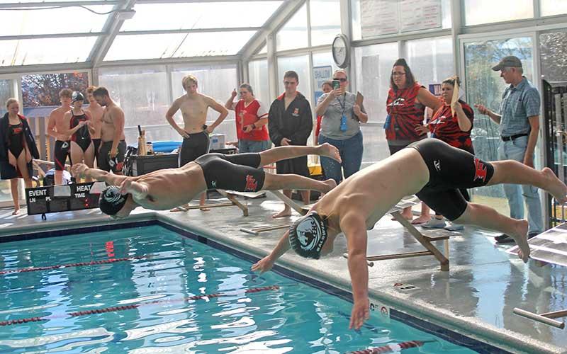 Press photo/Will Woolever - Senior Jose Gomez (left) and sophomore Isaiah Baldwin dive off the block for the 100-yard butterfly at Franklin Health &amp; Fitness Nov. 18.
