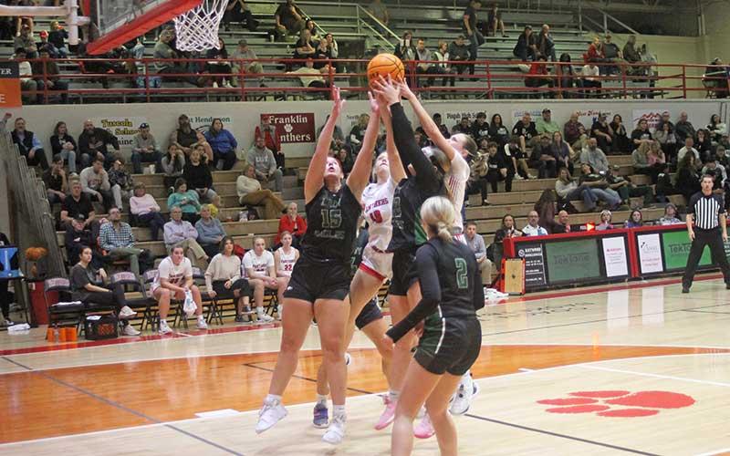 Press photo/Will Woolever - Juniors Payton Baty (white jersey, second from left) and Aubrey Haley fight for a rebound versus East Henderson Dec. 15.