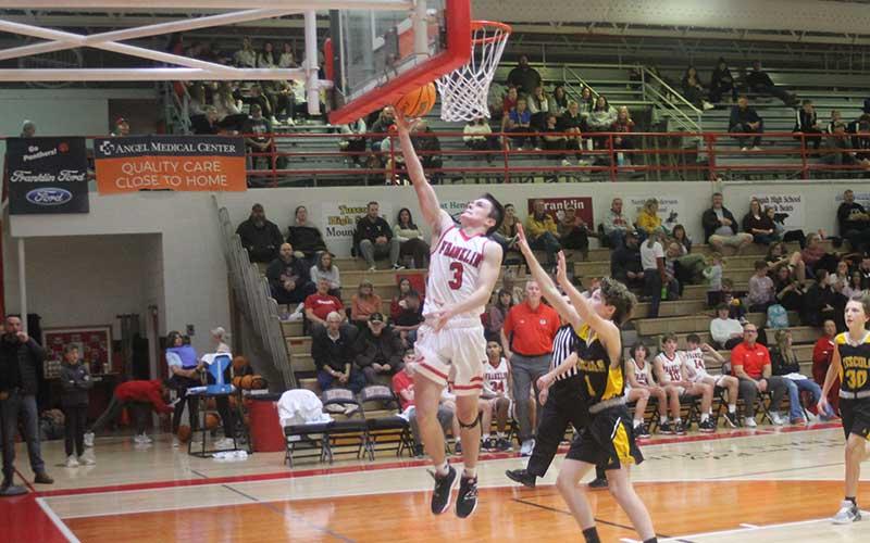 Sophomore point guard Aiden Pitts gets past Tuscola defenders on Tom Raby Court Dec. 19. (Press photo/Will Woolever)