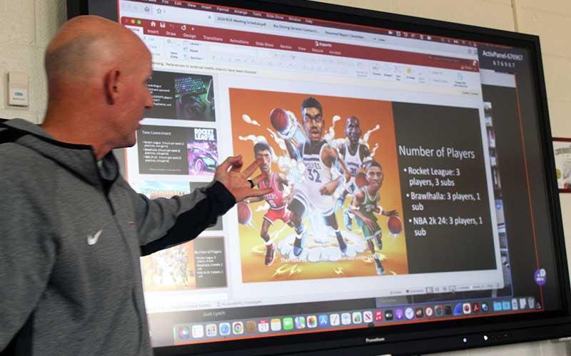 Press photo/Thomas Sherrill - Franklin High Career and Technical Education teacher Josh Brooks gives a presentation on Esports to the Macon County Board of Education Dec. 21.