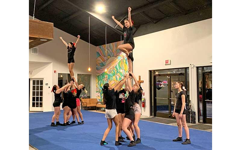 Press photo/Will Woolever - Panther cheer and dance prepares for the Universal Cheerleaders’ Association National High School Championships in Orlando Feb. 10 at a recent practice in Discover Church.