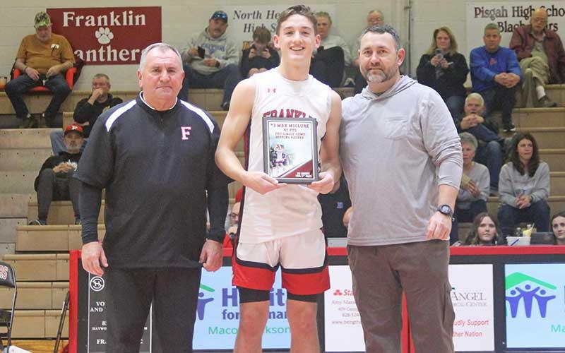 Press photo/Will Woolever - Junior guard Max McClure (center) is pictured with a plaque commemorating his school-record 47-point performance at Smoky Mountain Feb. 6. With him are FHS men’s varsity head coach Doug Plemmons (left) and athletic director Matt Bradley.