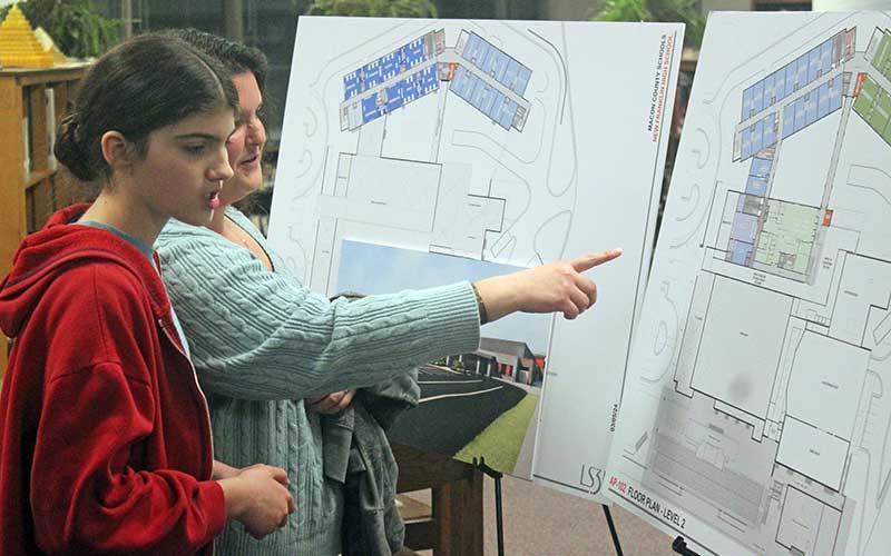 Press photo/Thomas Sherrill - Irene and Faith Lefebvre, 13, look at the Franklin High School new building renderings after a focus group on Wednesday, March 6.