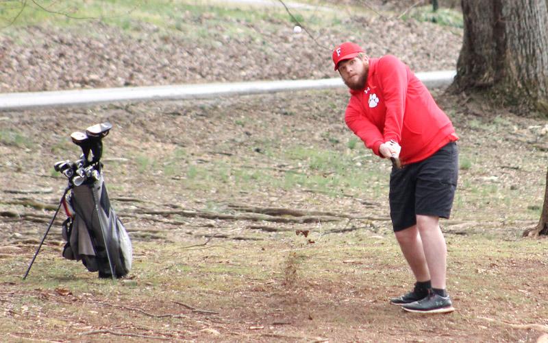 Press photo/Will Woolever. Senior Cooper Guffie chips out of the rough at the Franklin Golf Course versus Smoky Mountain Feb. 28.