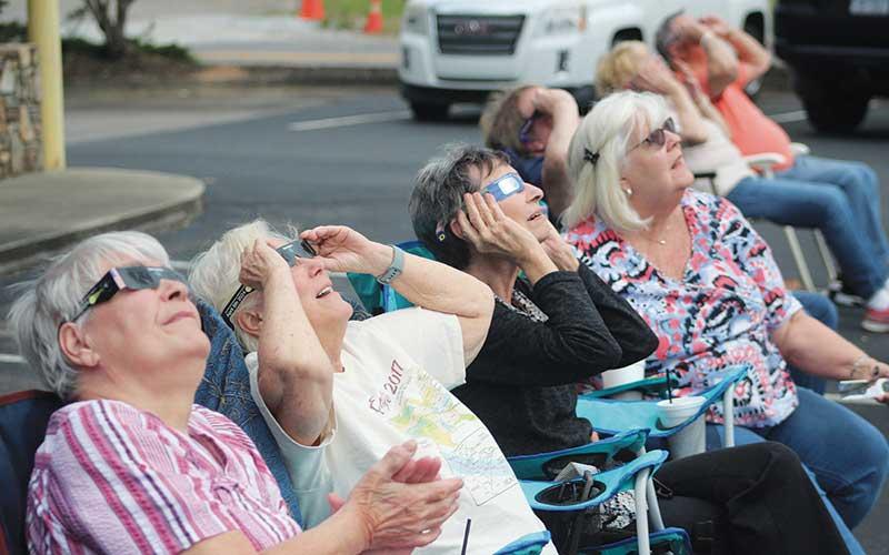 Press photo/Thomas Sherrill - Bonnie Phillips, Mary Spivey, Gil and Patty were among those gathered at the Franklin Chamber of Commerce to watch the solar eclipse on Monday, April 8. Look for more photos on The Franklin Press Facebook page.