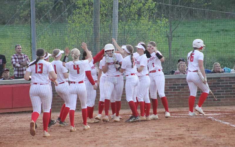 Press photo/Will Woolever - Sophomore Kendall Rumans (center, wearing batting helmet) is mobbed by teammates after a solo home run versus Pisgah April 19.