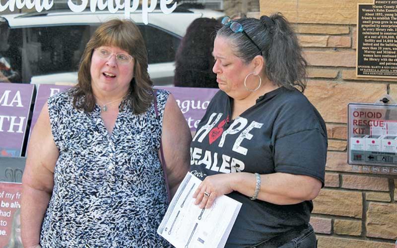 Press photo/Thomas Sherrill - Stephanie Almeida, founder and executive director of the Smoky Mountain Harm Reduction (right) and Lisa Hartman, mother of Brian Dills, speak during a May 6 press conference in downtown Franklin.