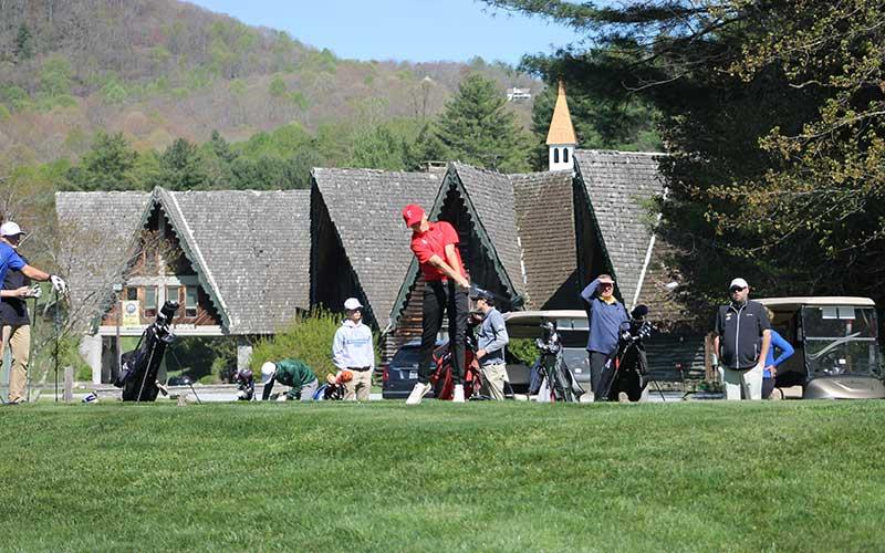Press photo/Will Woolever - Junior Cole Martin tees off on Hole 10 at Sky Valley Country Club in the first round of the Mountain Seven Conference Tournament April 22. The ball is visible between two spectators to Martin’s right.