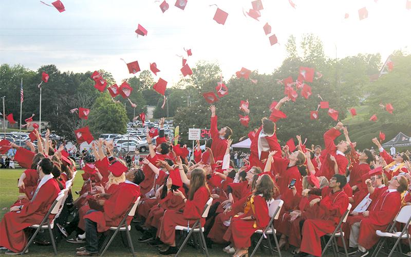 Press photos/Thomas Sherrill.  Franklin High School graduates toss their caps at the conclusion of the commencement ceremony on May 30.