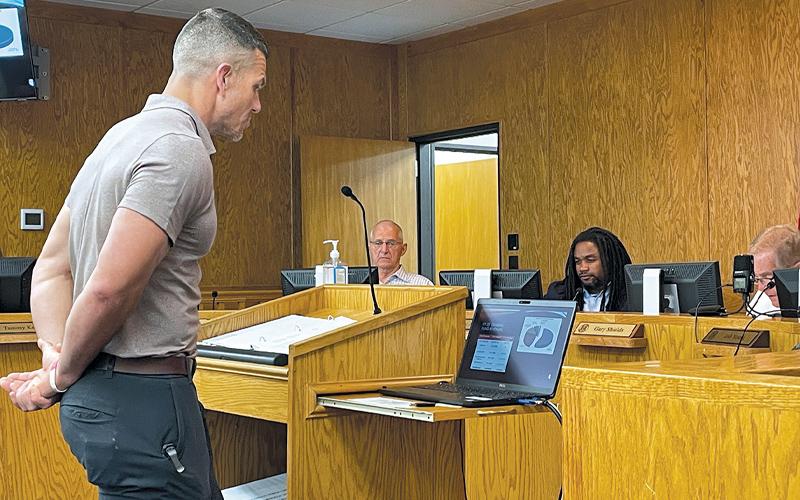 Press photo/Mia Overton. County Manager Derek Roland presents the proposed 2024-25 budget at a meeting on May 21. Also pictured are commissioners Paul Higdon, Danny Antoine and Chair Gary Shields.