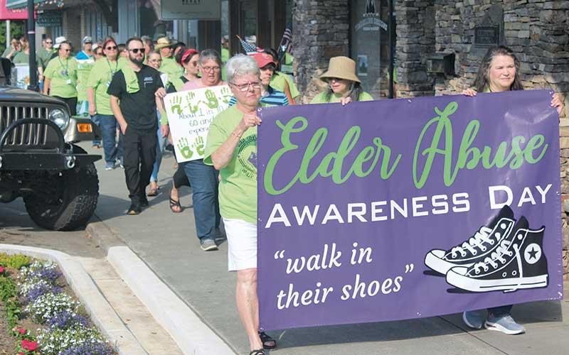 Press photos/Thomas Sherrill - Macon County Senior Services Director Kim Crawford and Macon County representative for the North Carolina Senior Tar Heel Legislature Pat Hedrick lead the Elder Abuse Awareness Day Walk in downtown Franklin on June 17.