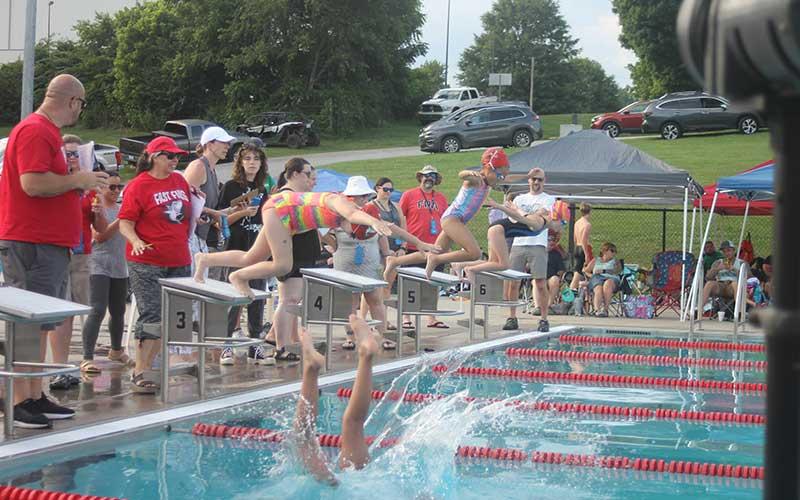 Press photo/Will Woolever - (From left) Kendall Adams, Leah Delgado and Emmie Monteith dive off their blocks for the girls 8 &amp; under 100-yard individual medley at the Macon county Rec Park June 13.