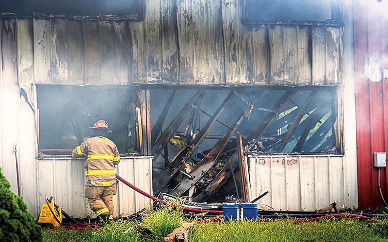 Photo/Bob Scott.  Eight fire departments from throughout the county responded to a July 17 fire at Liberty Wood Products. The company has temporarily halted work while they wait to get information about repairs to the building.