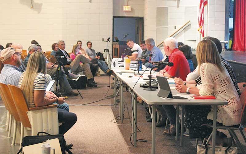 Press file photo - Pictured are the Macon County Board of Commissioners and the Board of Education meeting in May at the FHS Fine Arts Center. It has been suggested that the two boards hold joint monthly meetings to talk about the ongoing construction projects.