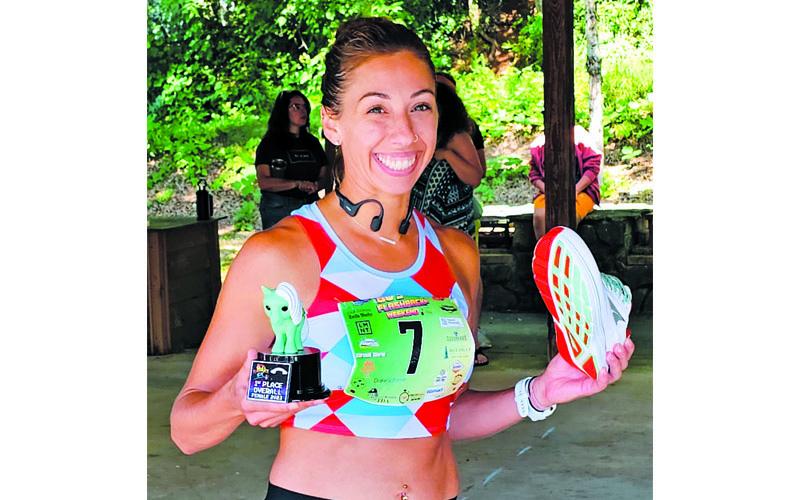 Photo submitted.  Franklin’s Kimberly Kate Jakushev shows off her First Place Overall trophy at last year’s 80s Flashback 5K.