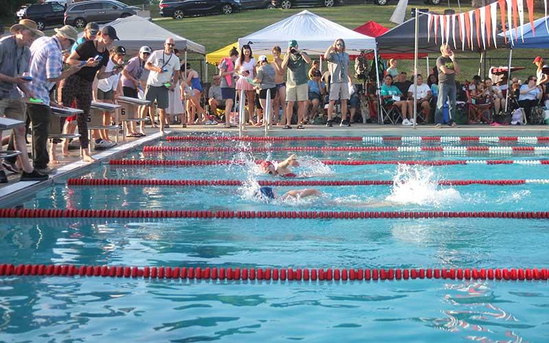 Press photo/Will Woolever - FAST’s Larken Lynch (facing camera) battles Highlands’ Nicole Shchelgachov in the 9-10 girls’ 100-yard inidividual medley July 2.