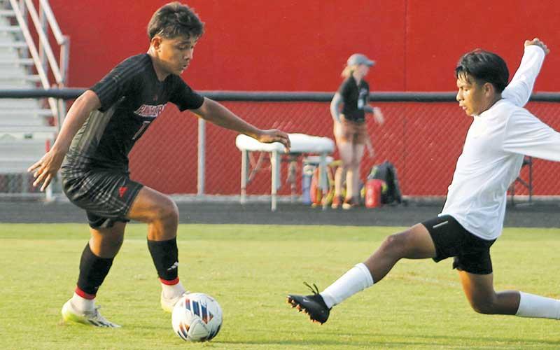 Senior Ulises Padron-Perez (left) puts a defender on skates in a match this fall.