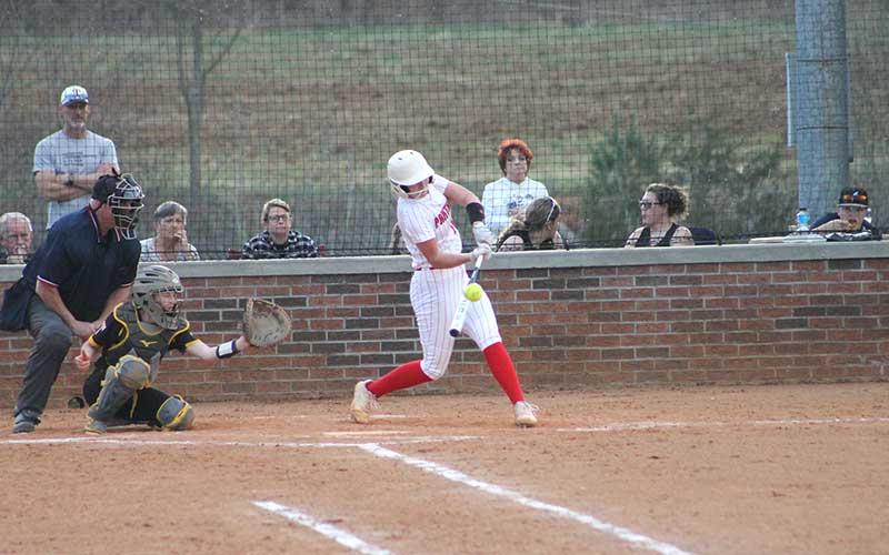 Press file photo - Rising junior phenom Kendall Rumans barrels up a pitch in a game versus East Henderson this March.