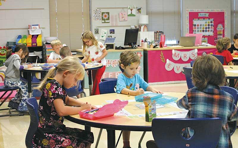 Press photo/Eric Braham - Students in Miss Evers first grade class begin the day coloring at Iotla Valley Elementary.