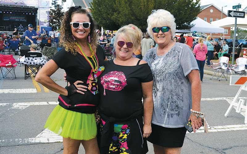 Press photos/Mia Overton - Sheila Green, Debbie Queen and Teresa Zoellner dressed the part for the 80s Flashback Weekend festivities on Saturday. See more photos on page B1 of today’s paper and on The Franklin Press Facebook page.