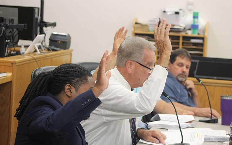 Press photo/Thomas Sherrill - Commissioners Danny Antoine, Gary Shields and Josh Young were the three votes needed to pass the new Franklin High financing plan on Aug. 13. At right is Commissioner John Shearl, who voted against the funding, along with Paul Higdon.