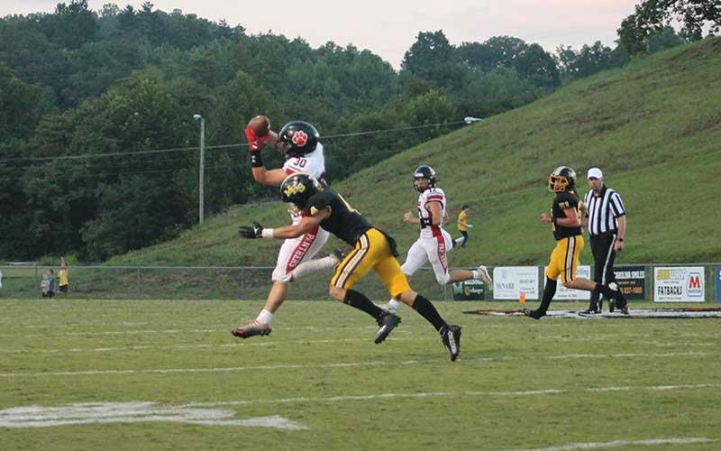 Press photo/Will Woolever - Sophomore quarterback Anderson Terrell (right) connects with junior Addix Sutton near the Panther sideline.