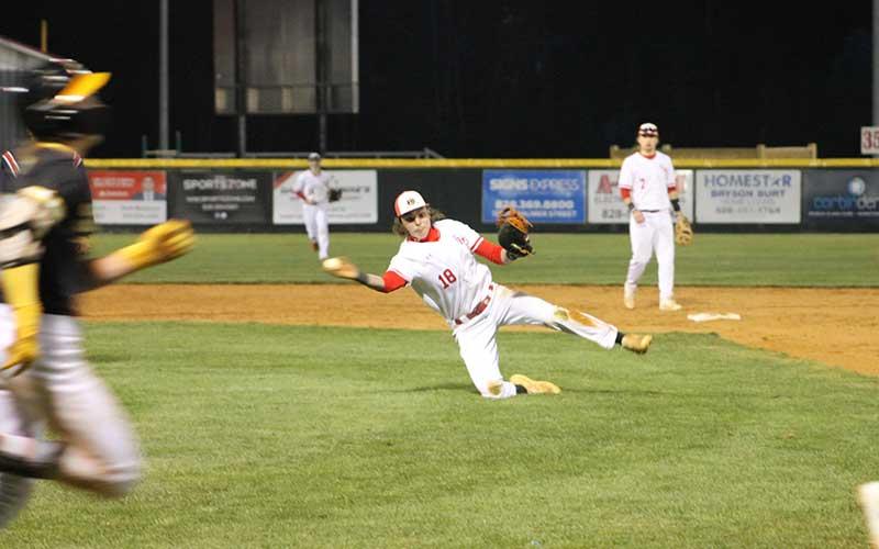Senior first baseman Jaxon Hursey makes an off-balance throw to first versus Tuscola on McConnell Field March 12. (Press photo/Will Woolever)