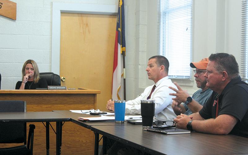 Press photo/Thomas Sherrill - Macon County Board of Education member Diedre Breeden (left) and Macon County Schools administrators Todd Gibbs, Tracy Tallent and Mickey Noe during the emergency meeting on Friday, Sept. 6.