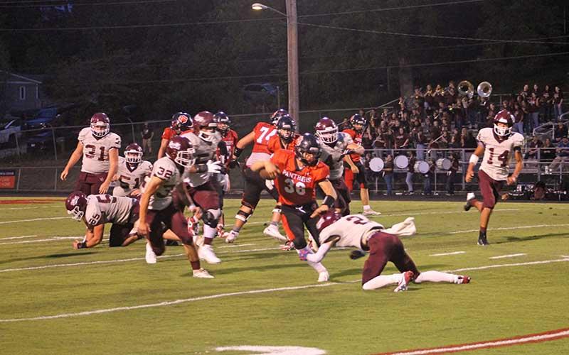 Press photo/Will Woolever - Freshman fullback Garrett Young tries to break a Swain tackle at the Panther Pit Aug. 6.
