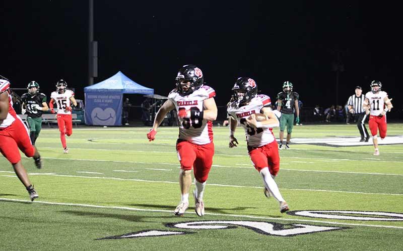 Press photo/Vickie Carpenter - Junior Aiden Pitts (right) returns his second-quarter interception for a touchdown with help from Addix Sutton in Franklin’s 48-8 win at East Henderson Sept. 20.