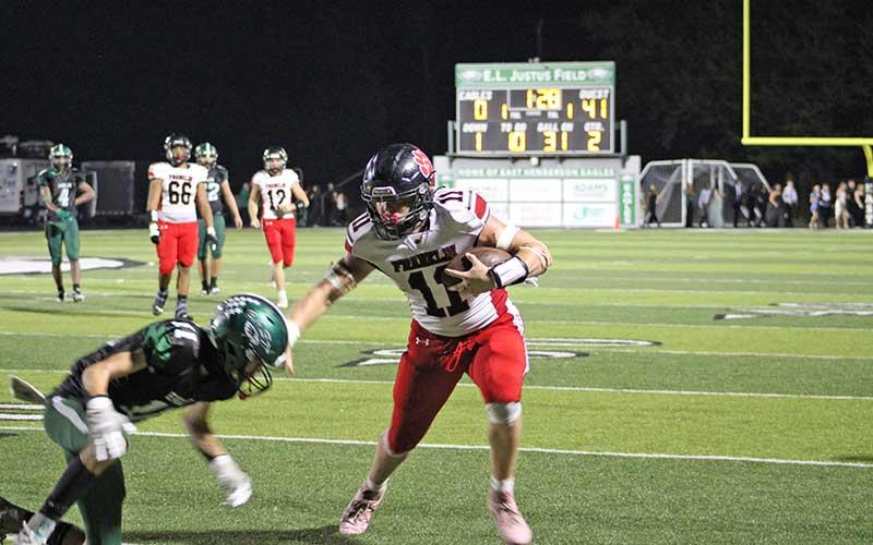 Press photo/Vickie Carpenter - Senior Braydon Hervey stiffarms a defender for some of his 708 all-purpose yards through just four games this season.