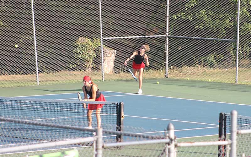 Press photo/Will Woolever - Abigail Angel (right) serves while Caroline Deal guards the net in Franklin’s #2 doubles match vs. Pisgah Aug. 26.