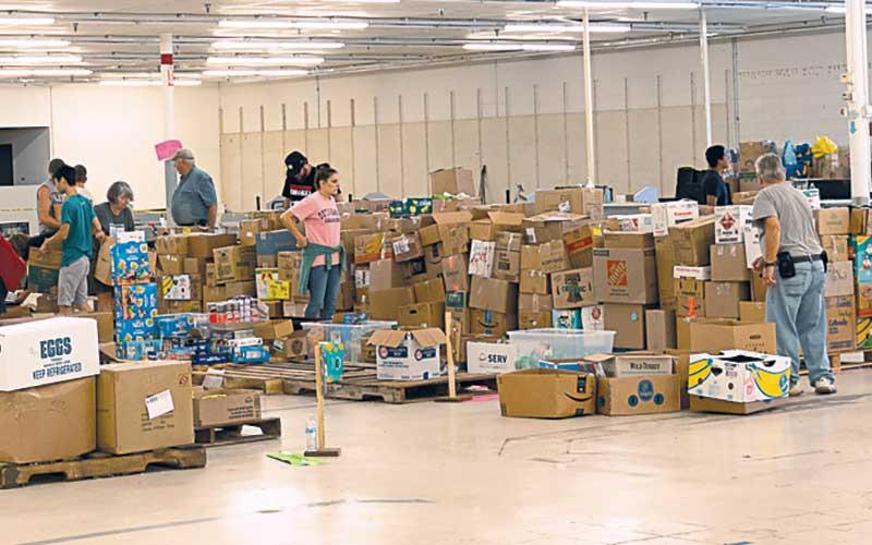 Photo/Bob Scott – Over the past weekend, boxes and boxes of supplies were delivered to the GR828 intake and redistribution center at the old Kmart in Westgate Shopping Center. The center has now moved to Discover Church.