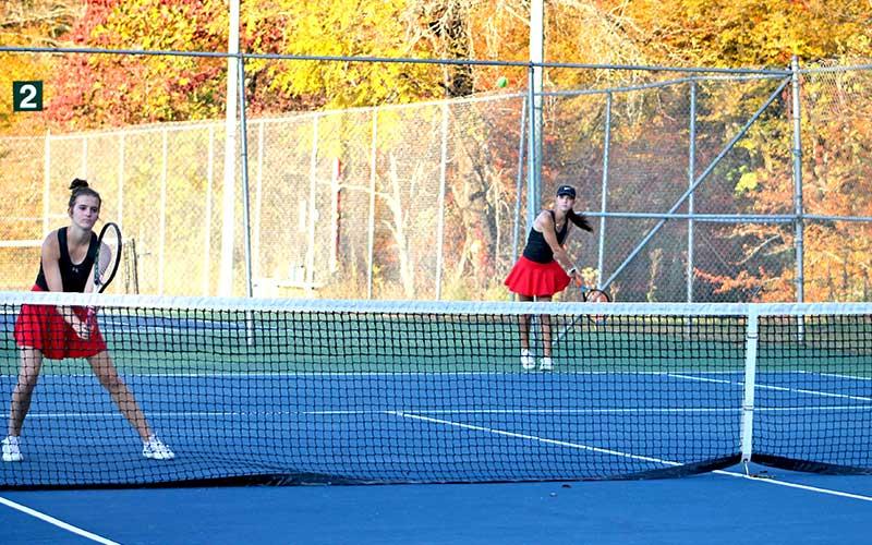 Press photo/Will Woolever - Senior Caroline Deal (left) guards the net while fellow senior Maci Stork serves versus South Rowan Oct. 23.
