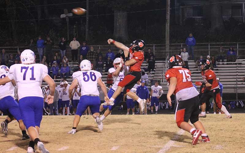 Press photo/Will Woolever - Sophomore quarterback Anderson Terrell takes a hit but delivers the throw versus West Henderson Oct. 25.