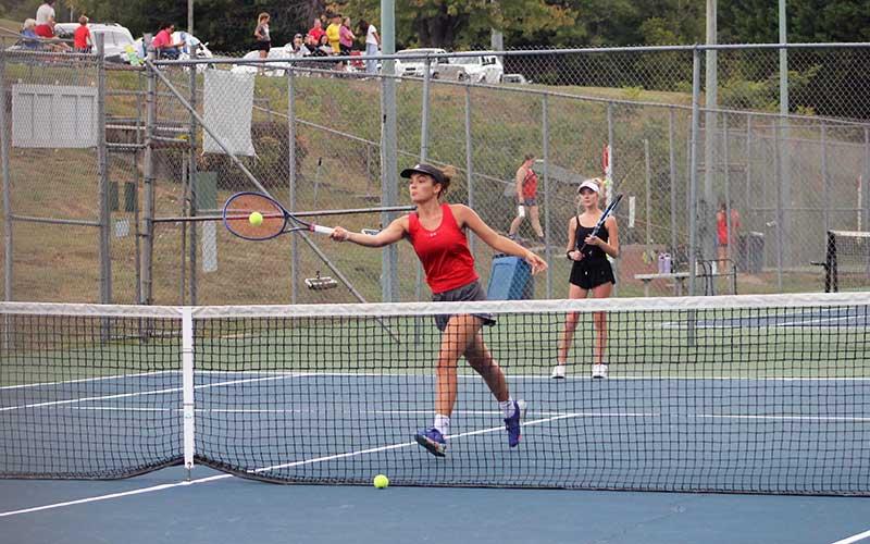 Kate Phillips volleys a ball while Abigail Angel guards the baseline in Franklin’s #1 doubles match versus East Henderson Sept. 16. (Press file photo)