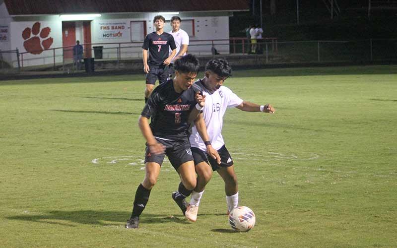 Press photo/Will Woolever - Senior Miguel Cruz fights for possession in Franklin’s stunning come-from-behind win over East Henderson Oct. 9.