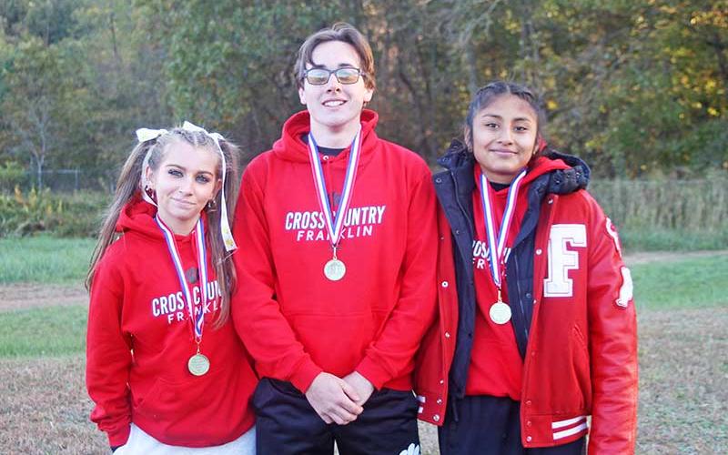 Press photo/Will Woolever - Franklin’s top distance runners are pictured with their All-Conference medals at the Mountain Seven Championship meet in Canton Oct. 16. From left are Morgan Cress, Matheson Post and Amy Mendoza Lopez.